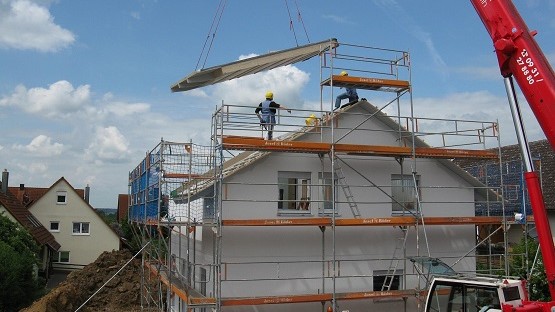 Neues Einfamilienhaus bekommt ein Dach aufgesetzt